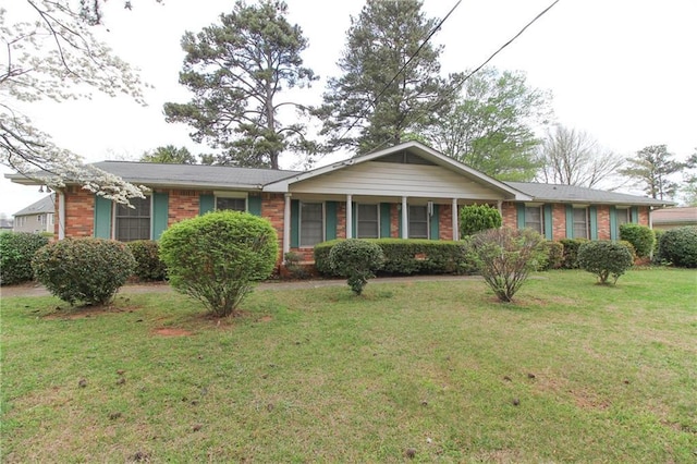 single story home with brick siding and a front yard
