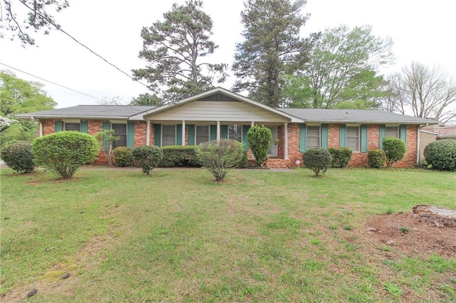single story home with a front lawn and brick siding