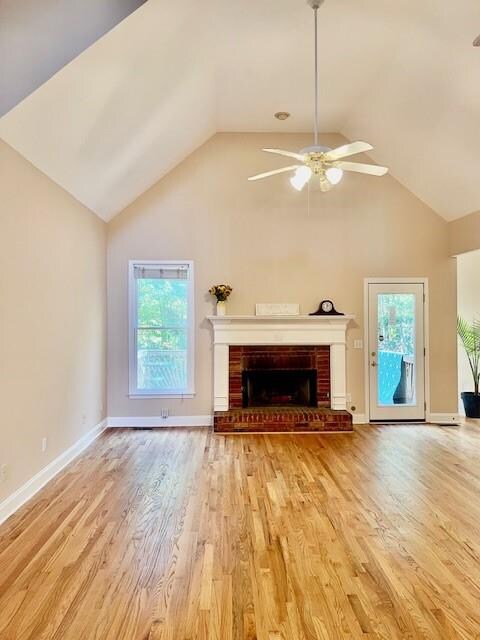 kitchen featuring white cabinetry, sink, stainless steel appliances, light hardwood / wood-style flooring, and ornamental molding