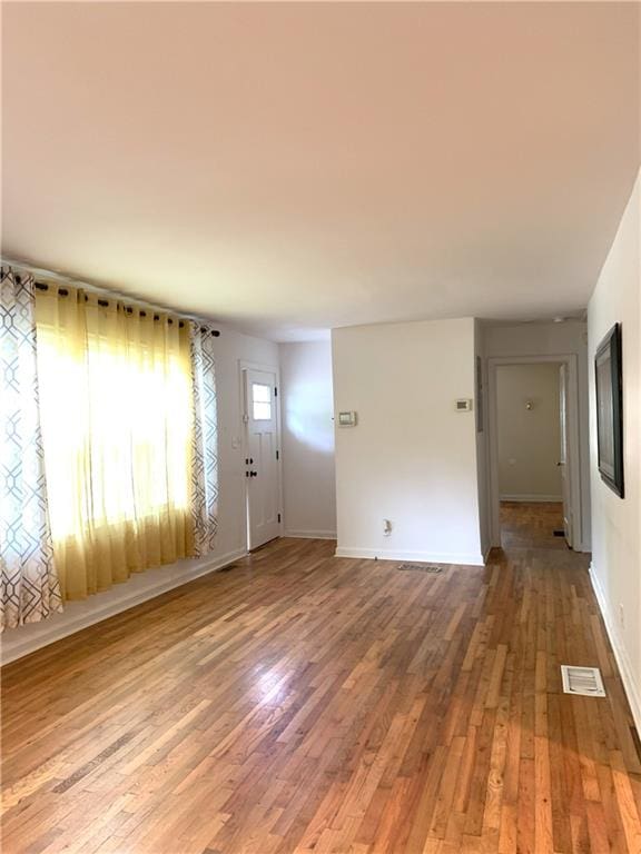 3604 Orchard Cir, Decatur, GA 30032 - unfurnished living room featuring wood finished floors and baseboards