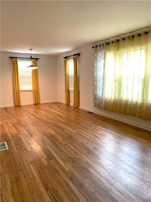 3604 Orchard Cir, Decatur, GA 30032 - empty room with healthy amount of natural light and wood finished floors