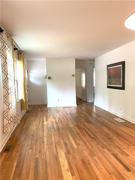 3604 Orchard Cir, Decatur, GA 30032 - unfurnished living room with wood-type flooring and baseboards