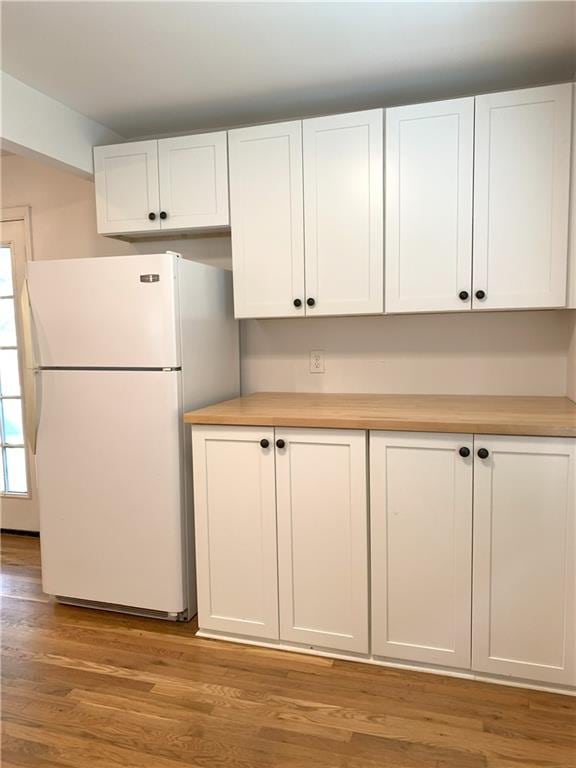 3604 Orchard Cir, Decatur, GA 30032 - kitchen with freestanding refrigerator, white cabinetry, light countertops, and light wood finished floors