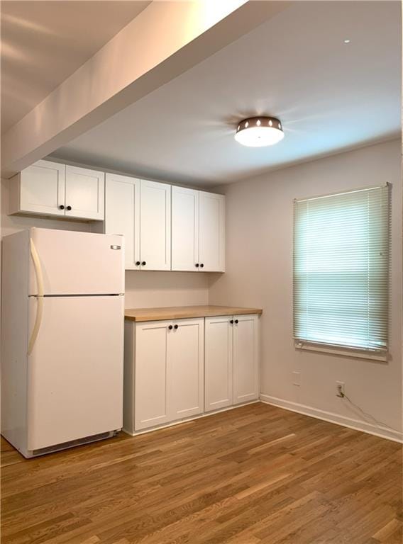 3604 Orchard Cir, Decatur, GA 30032 - kitchen with freestanding refrigerator, white cabinets, light wood finished floors, and light countertops