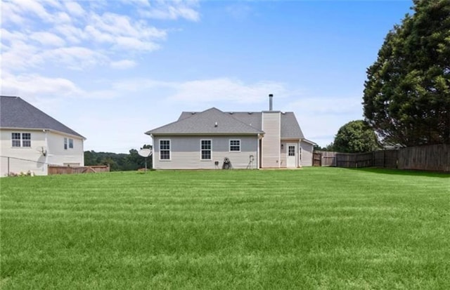 rear view of house with a lawn