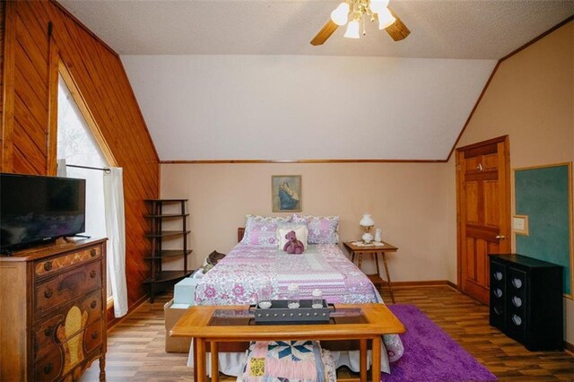 bedroom featuring a textured ceiling, wood finished floors, ceiling fan, and vaulted ceiling