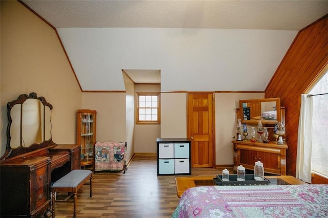 bedroom featuring wood finished floors and vaulted ceiling