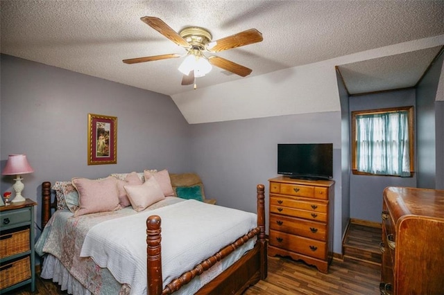 bedroom with a textured ceiling, wood finished floors, a ceiling fan, and vaulted ceiling