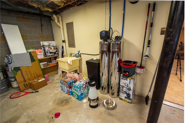 unfinished basement with concrete block wall and electric panel