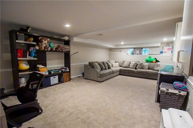 living area with recessed lighting, visible vents, baseboards, and light colored carpet