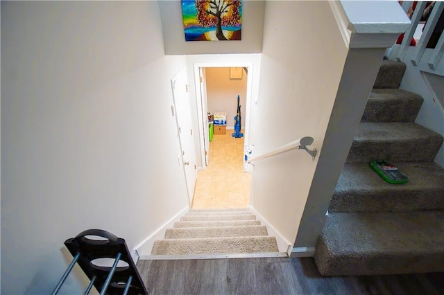 stairway with baseboards and wood finished floors