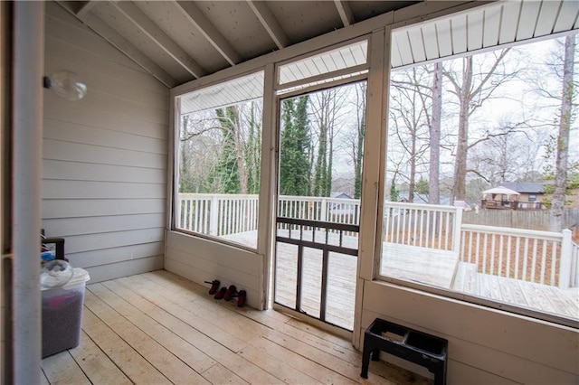 sunroom / solarium featuring lofted ceiling