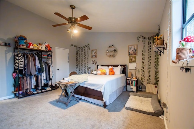 carpeted bedroom with lofted ceiling, a closet, and ceiling fan