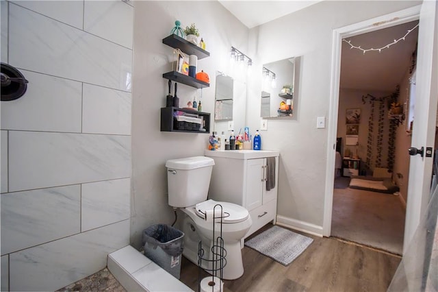 bathroom with vanity, toilet, and wood finished floors