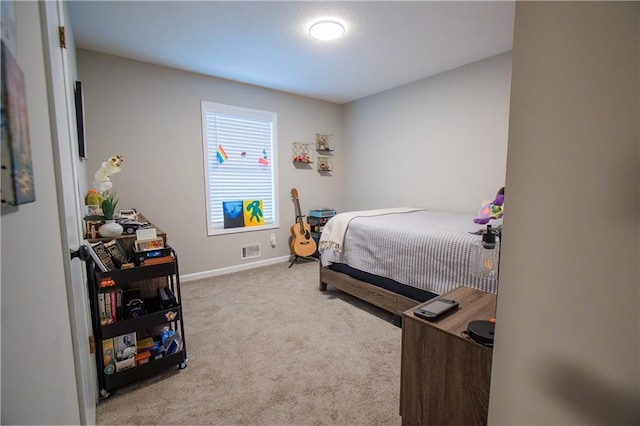 bedroom featuring light colored carpet, visible vents, and baseboards