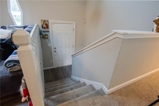 stairway featuring wood finished floors and baseboards