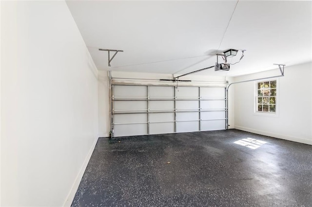 garage featuring a garage door opener and baseboards