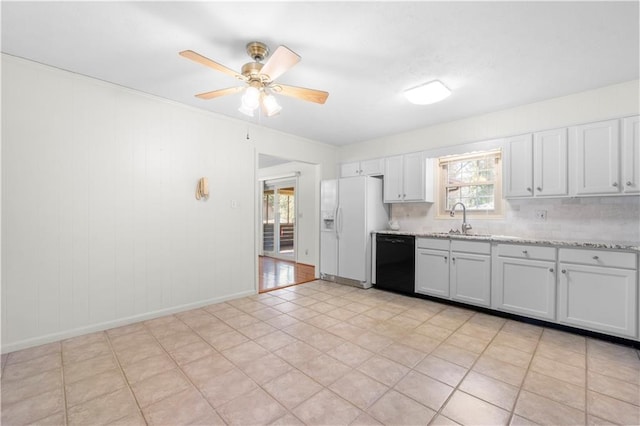 kitchen featuring a ceiling fan, dishwasher, light stone counters, white fridge with ice dispenser, and a sink