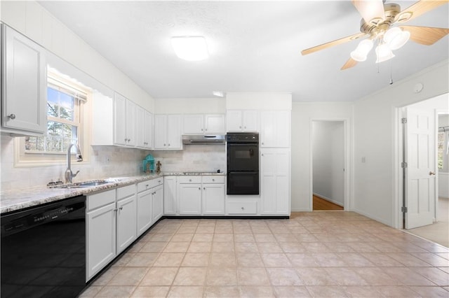 kitchen with a sink, under cabinet range hood, black appliances, white cabinetry, and backsplash