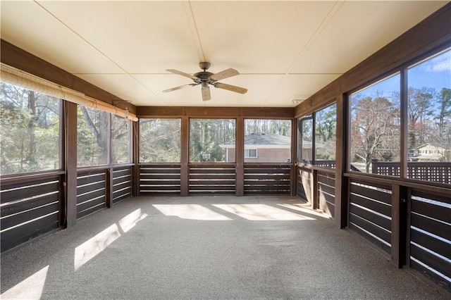 unfurnished sunroom with ceiling fan