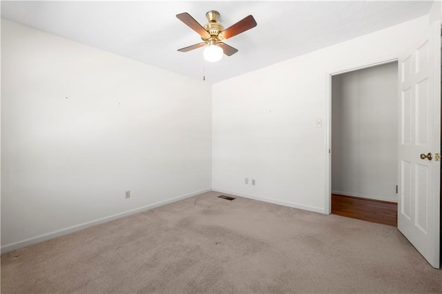 unfurnished room featuring a ceiling fan, carpet flooring, visible vents, and baseboards