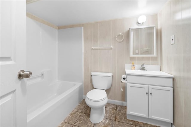 bathroom featuring toilet, baseboards, and vanity