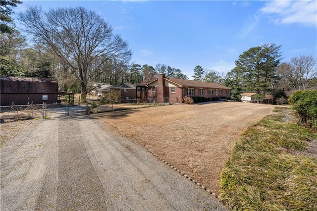 single story home featuring a gate, fence, and a front lawn