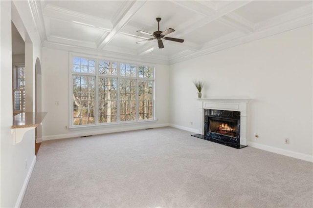 unfurnished living room featuring carpet, a premium fireplace, coffered ceiling, beamed ceiling, and baseboards