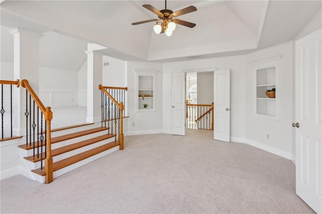 interior space featuring lofted ceiling, built in shelves, stairway, and baseboards