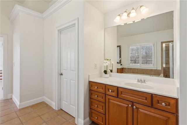 full bathroom featuring tile patterned flooring, a shower with shower door, vanity, and baseboards