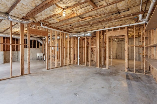 miscellaneous room with concrete floors and a sink