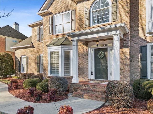 property entrance featuring brick siding