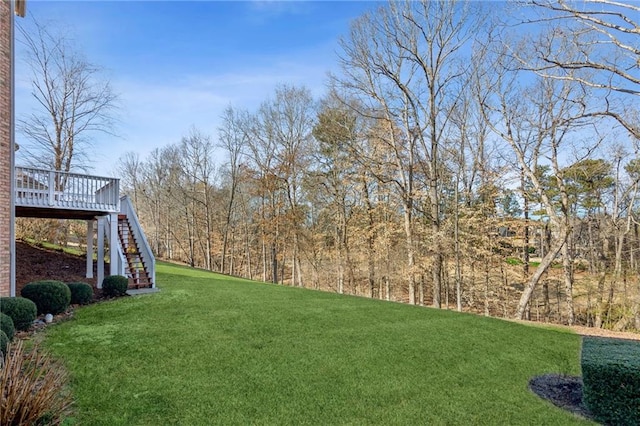 view of yard with stairs and a wooden deck