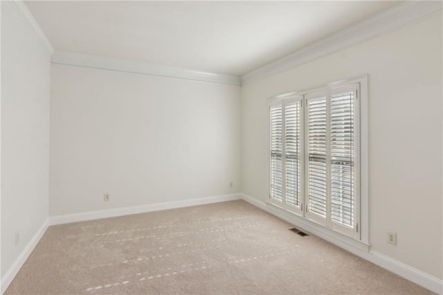 carpeted empty room featuring visible vents, crown molding, and baseboards