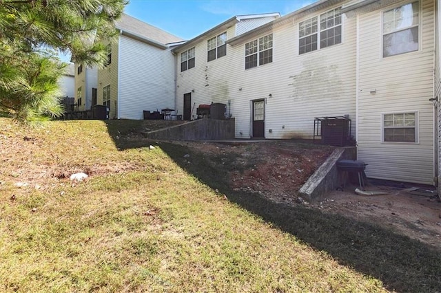 back of property with a yard and a patio area