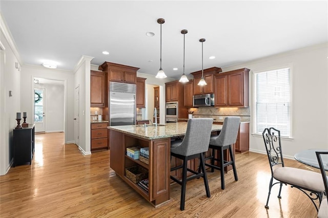 1215 Renaissance Ct SE, Mableton, GA 30126 - kitchen with appliances with stainless steel finishes, ornamental molding, open shelves, tasteful backsplash, and brown cabinets