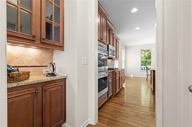 1215 Renaissance Ct SE, Mableton, GA 30126 - kitchen featuring stainless steel appliances, tasteful backsplash, light stone countertops, glass insert cabinets, and recessed lighting