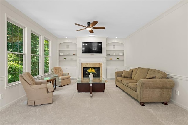 1215 Renaissance Ct SE, Mableton, GA 30126 - carpeted living room featuring a fireplace with flush hearth, ceiling fan, built in features, and ornamental molding