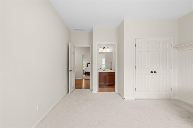 1215 Renaissance Ct SE, Mableton, GA 30126 - unfurnished bedroom with light carpet, a closet, and ensuite bathroom