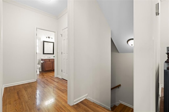 1215 Renaissance Ct SE, Mableton, GA 30126 - corridor featuring an upstairs landing, light wood-type flooring, and ornamental molding