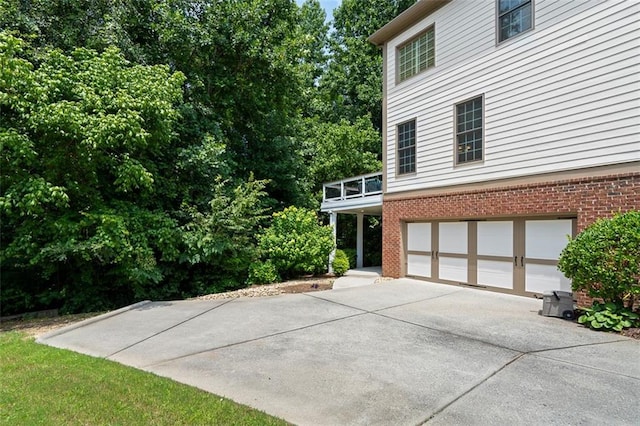 1215 Renaissance Ct SE, Mableton, GA 30126 - view of side of home featuring concrete driveway, brick siding, and an attached garage