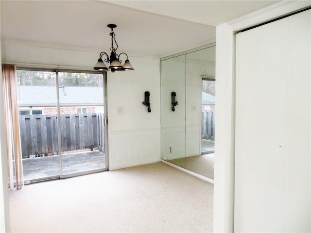 5586 Kingsport Dr, Atlanta, GA 30342 - unfurnished dining area with a chandelier and carpet flooring