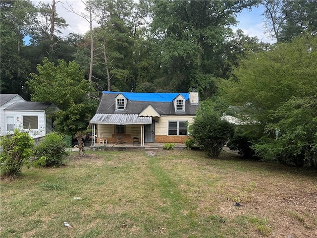 cape cod house with a front lawn