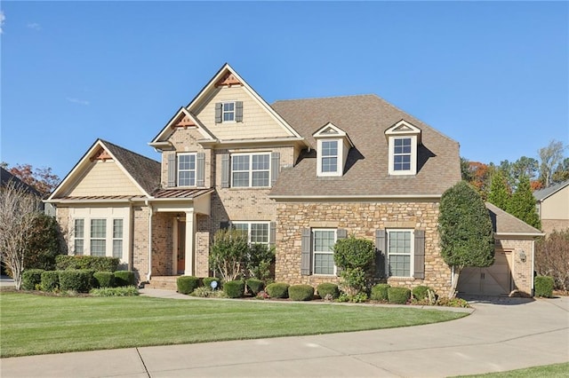 view of front of house featuring a front yard and a garage