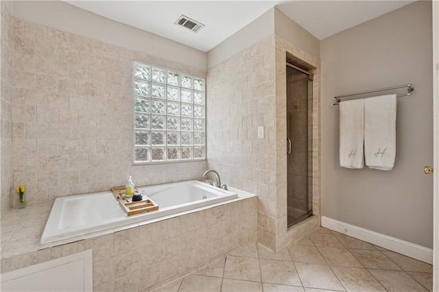 183 Whitefoord Ave NE, Atlanta, GA 30307 - bathroom featuring a stall shower, a garden tub, tile patterned flooring, baseboards, and tile walls
