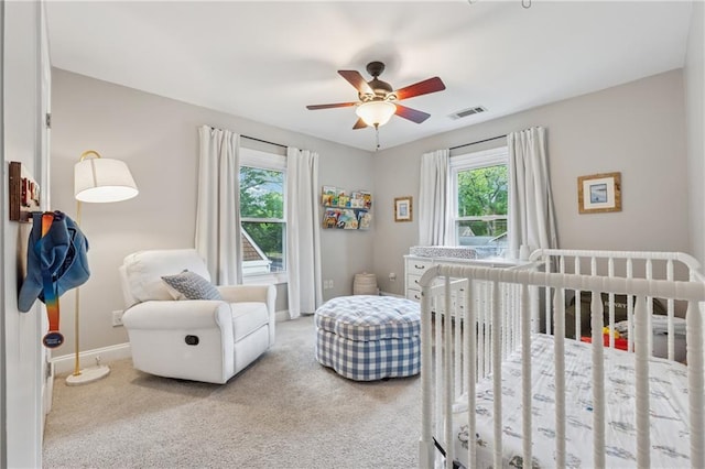 183 Whitefoord Ave NE, Atlanta, GA 30307 - carpeted bedroom featuring baseboards, a crib, and ceiling fan