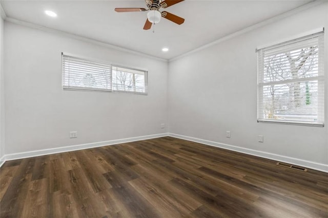 spare room with visible vents, crown molding, baseboards, dark wood-style floors, and a ceiling fan