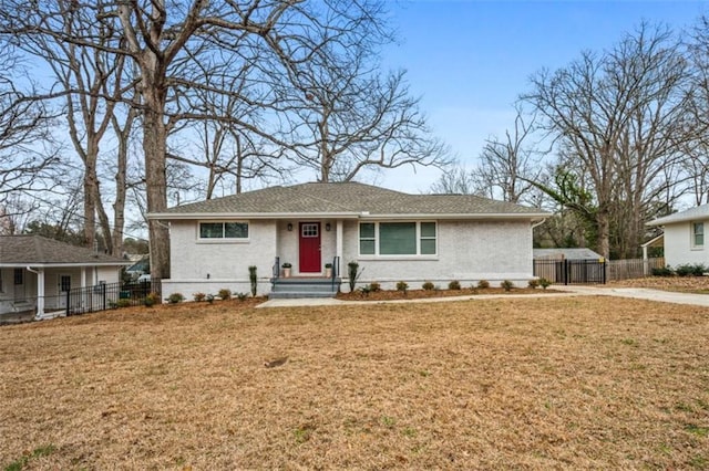 ranch-style home with brick siding, a front yard, and fence