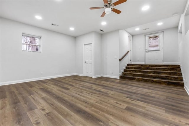 below grade area with stairway, recessed lighting, wood finished floors, and baseboards