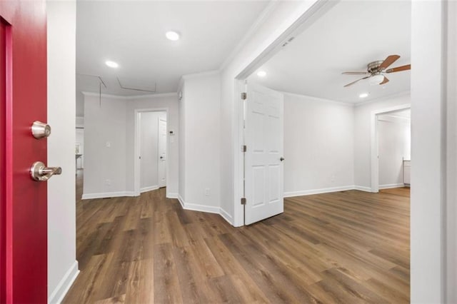 interior space with baseboards, attic access, ornamental molding, recessed lighting, and wood finished floors